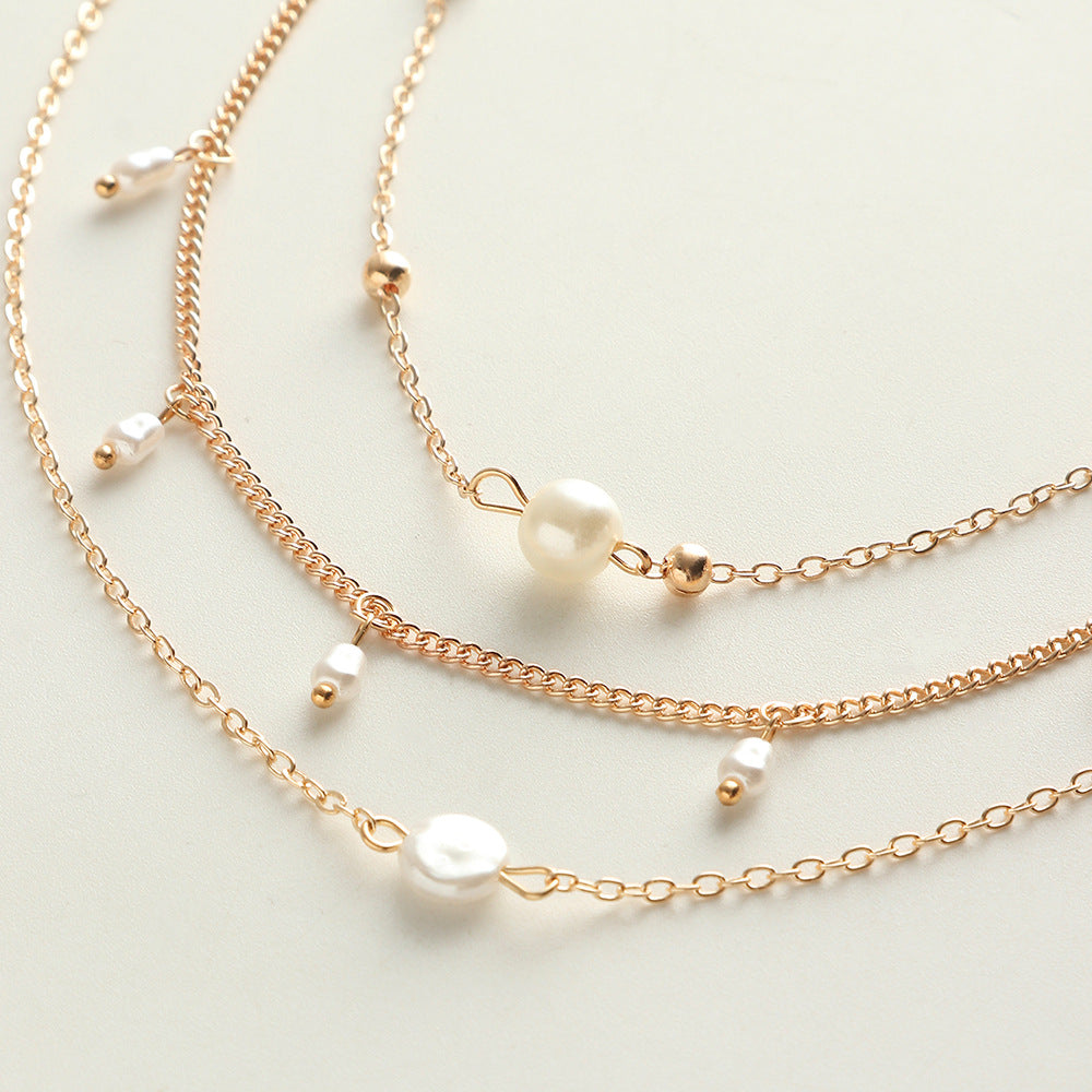 Layered Heart Necklace adorned with Pearl accents.