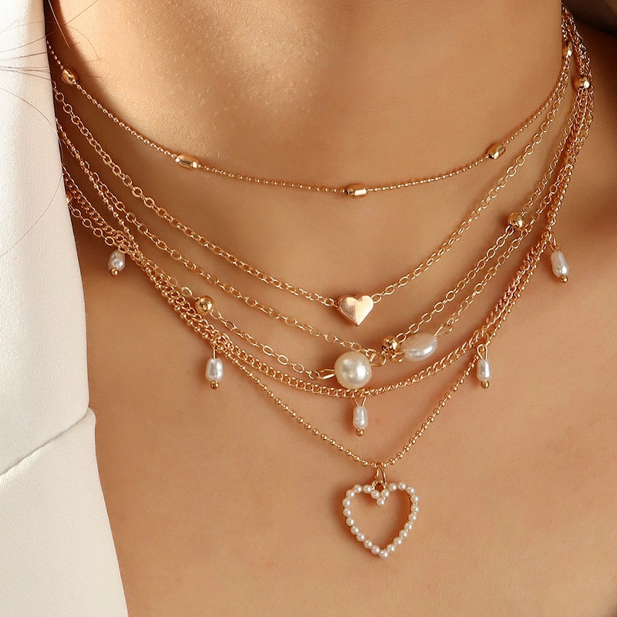 Layered Heart Necklace adorned with Pearl accents.